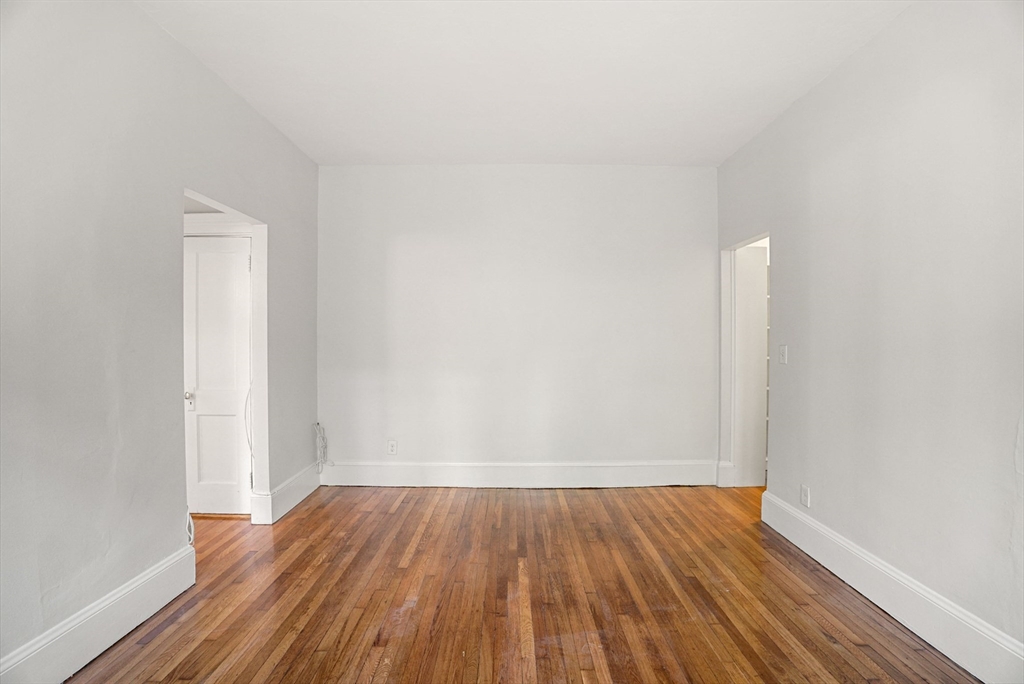 30 Kilsyth Road, Unit 3 Brookline, MA 02445 - Photo 3 of 11 a view of a room with wooden floor and white walls