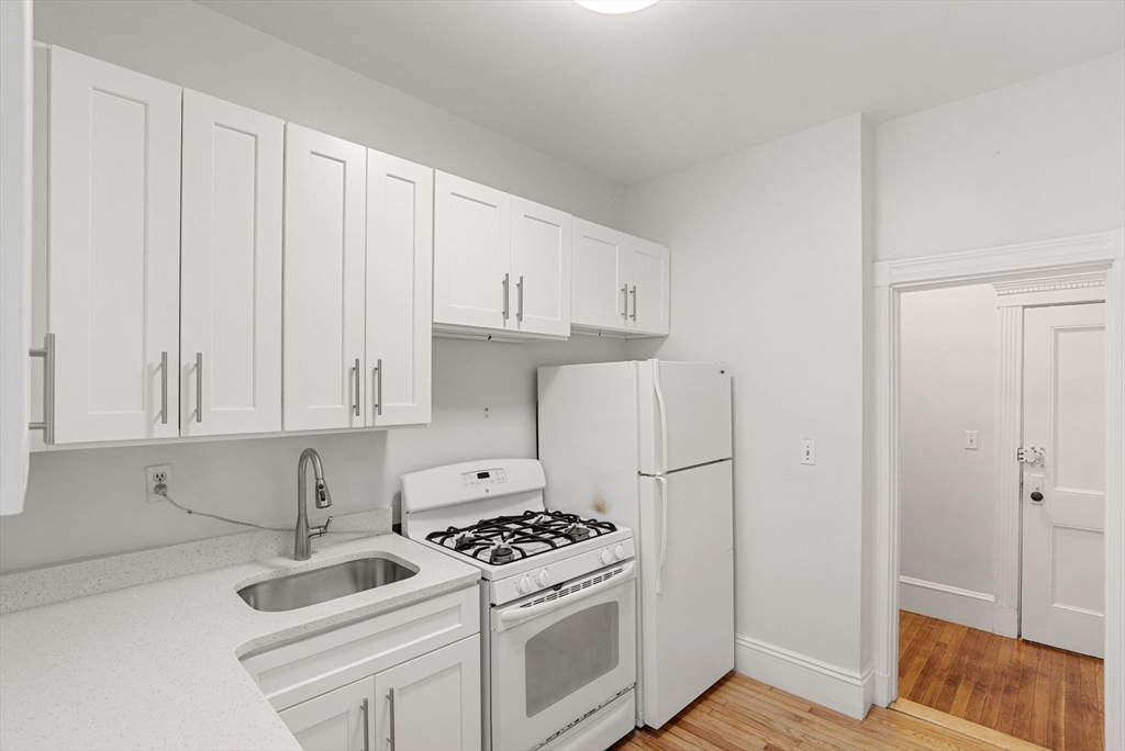 30 Kilsyth Road, Unit 3 Brookline, MA 02445 - Photo 6 of 11 a kitchen with cabinets and appliances