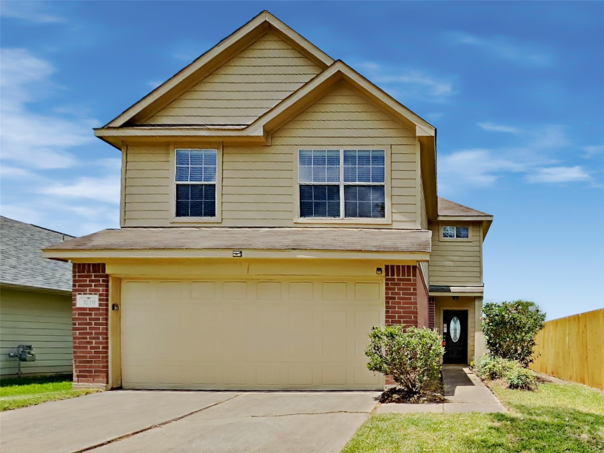 a view of a house with wooden fence