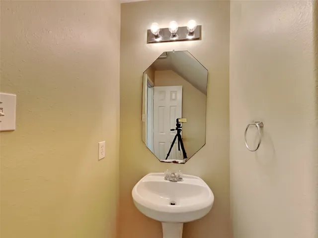 a bathroom with a sink and mirror