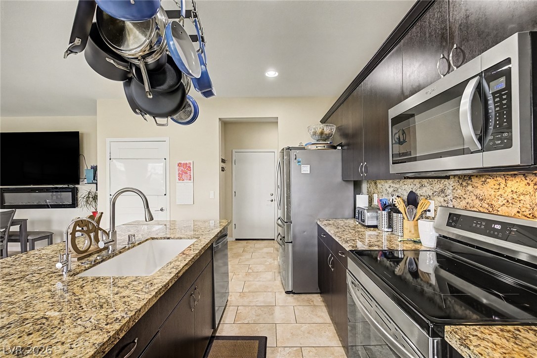 4914 East Beacon Ridge Drive Pahrump, NV 89061 - Photo 14 of 34 Granite counters and stainless steel appliances outfit this sleek, contemporary kitchen.