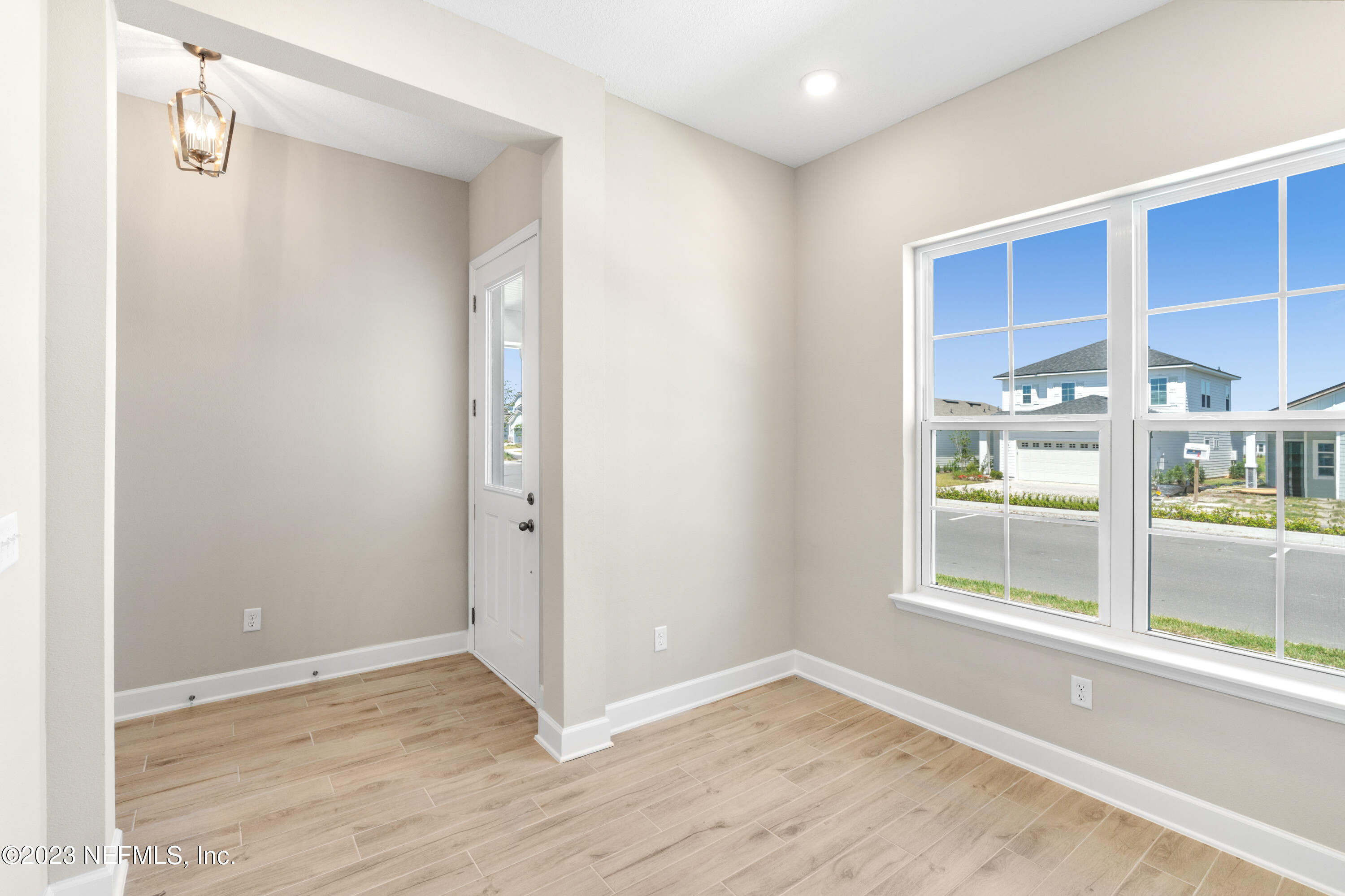 92 Alston Drive St. Augustine, FL 32092 - Photo 5 of 14 a view of an empty room with a window and wooden floor