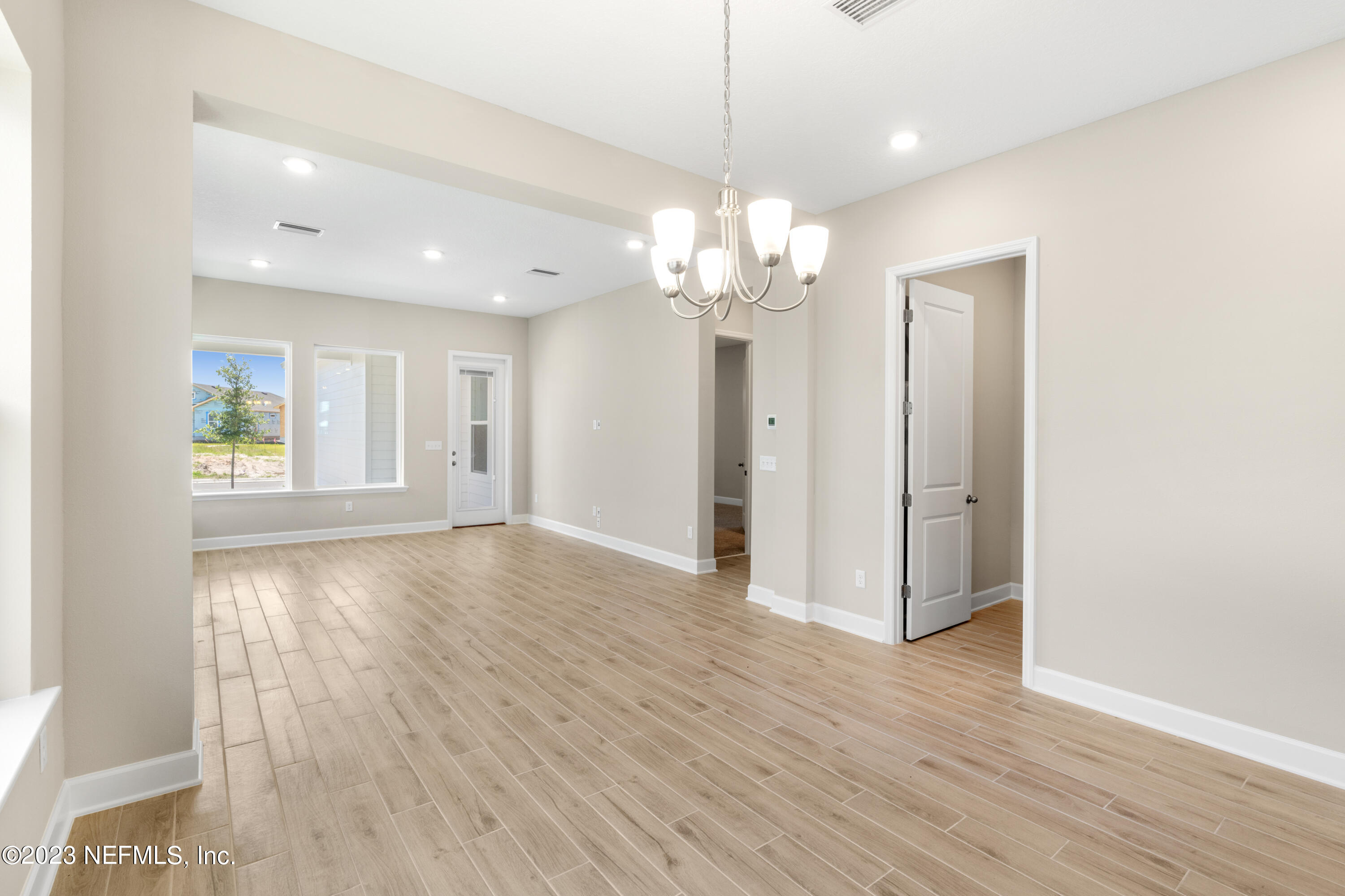92 Alston Drive St. Augustine, FL 32092 - Photo 8 of 14 a view of an empty room with wooden floor and a window