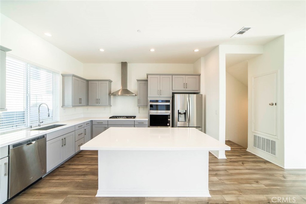 209 Merit Irvine, CA 92618 - Photo 3 of 39 a large kitchen with a large counter top appliances and cabinets