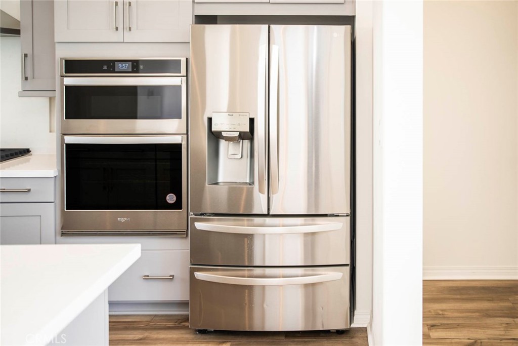209 Merit Irvine, CA 92618 - Photo 33 of 39 a kitchen with kitchen island a counter top and stainless steel appliances