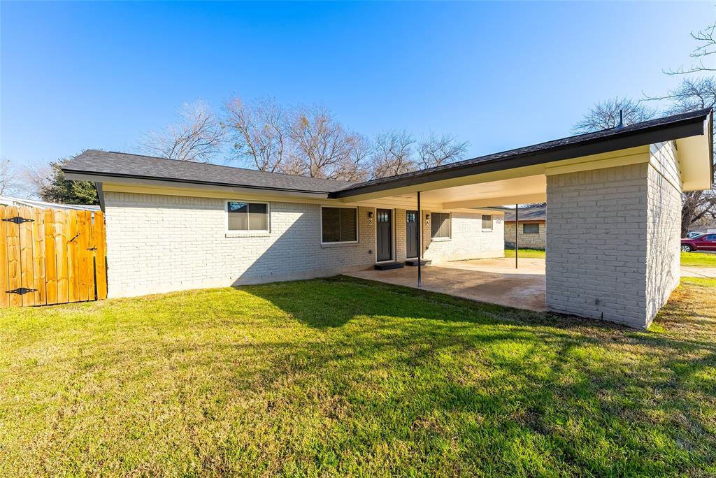 4306 Shallowbrook Trail Austin, TX 78744 - Photo 13 of 16 Back of house featuring a patio, brick siding, and a carport