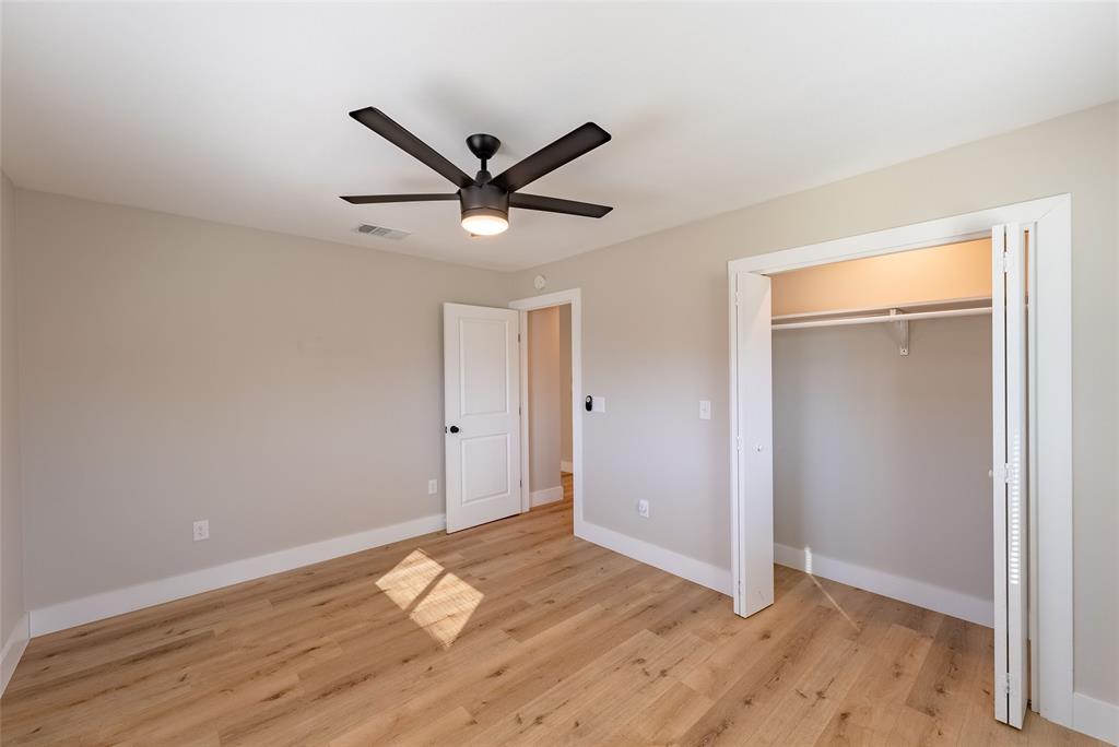 4306 Shallowbrook Trail Austin, TX 78744 - Photo 9 of 16 Unfurnished bedroom featuring light wood-type flooring, a closet, and ceiling fan