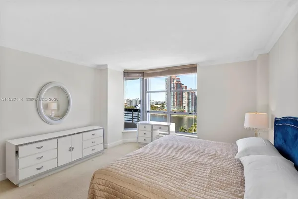 a view of a bedroom with a bed and a dresser