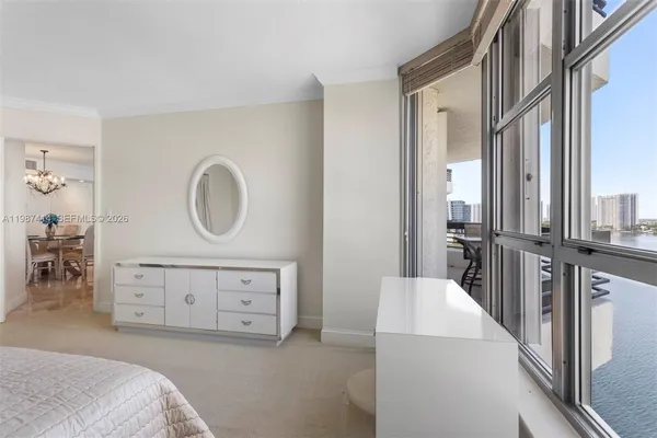 a view of a balcony with furniture and a floor to ceiling window