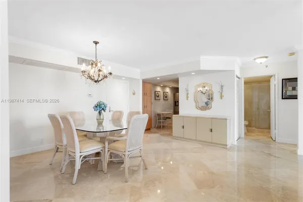 a dining room with furniture and a chandelier