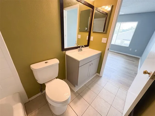 a white toilet sitting next to a bathroom sink