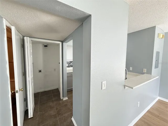 a view of a hallway with closet and wooden floor