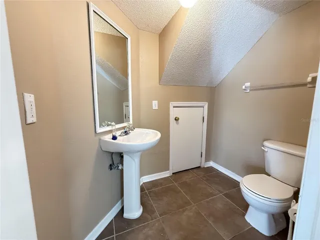 a bathroom with a sink toilet and a mirror