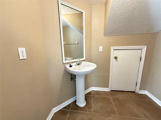 a bathroom with a sink a mirror and a shower