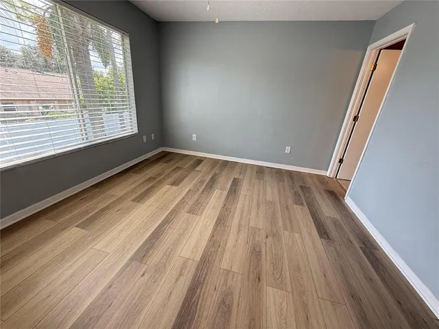 a view of a room with wooden floor and staircase