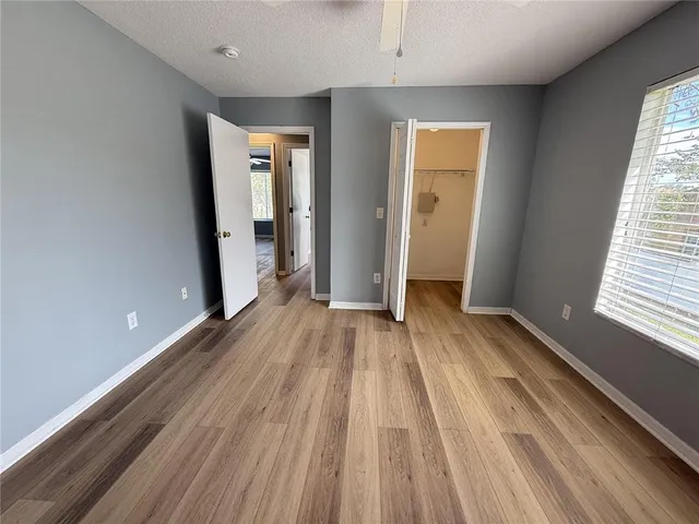 a view of a room with wooden floor and window