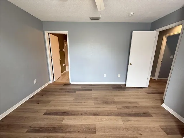 a view of room with window and wooden floor