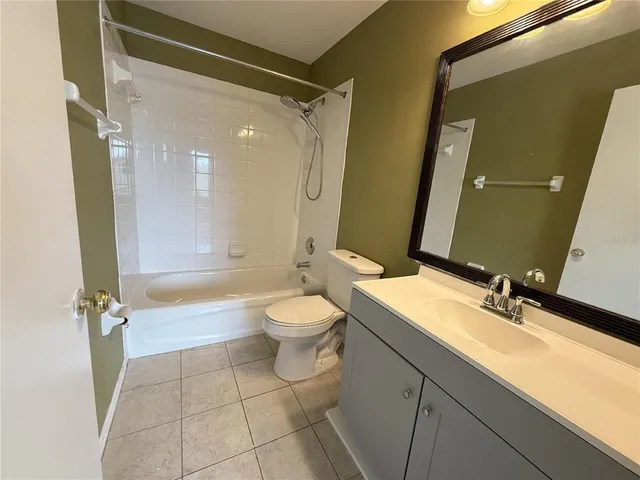a bathroom with a double vanity sink toilet mirror and shower
