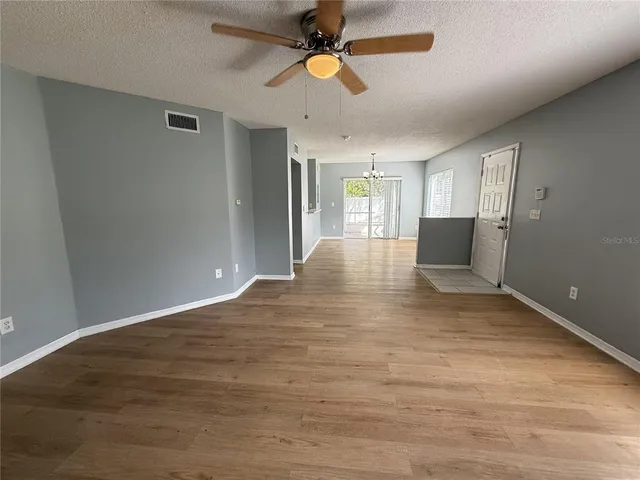 a view of an empty room with window and cabinet