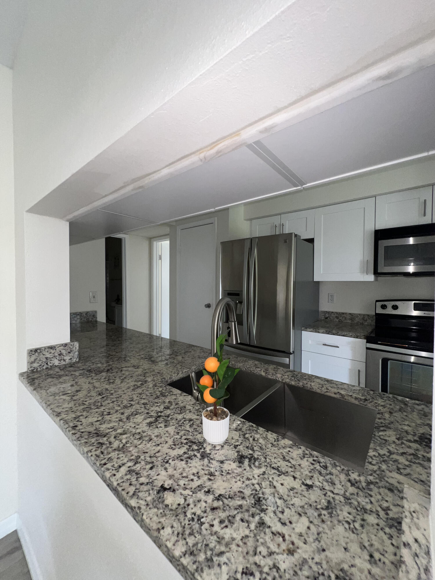 899 Riverside Drive, Unit 620 Coral Springs, FL 33071 - Photo 11 of 46 a kitchen with stainless steel appliances granite countertop a sink stove and refrigerator