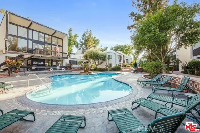 a view of a swimming pool with sitting area