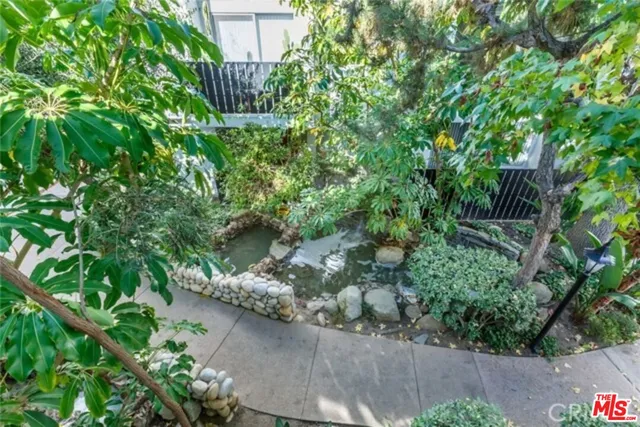 a view of a kitchen with refrigerator and white cabinets