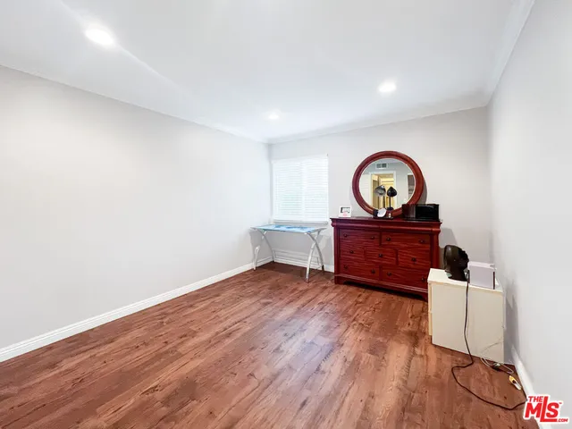 a living room with couch and a wooden floor