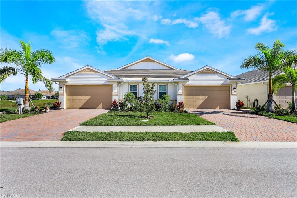 a front view of a house with a yard and garage
