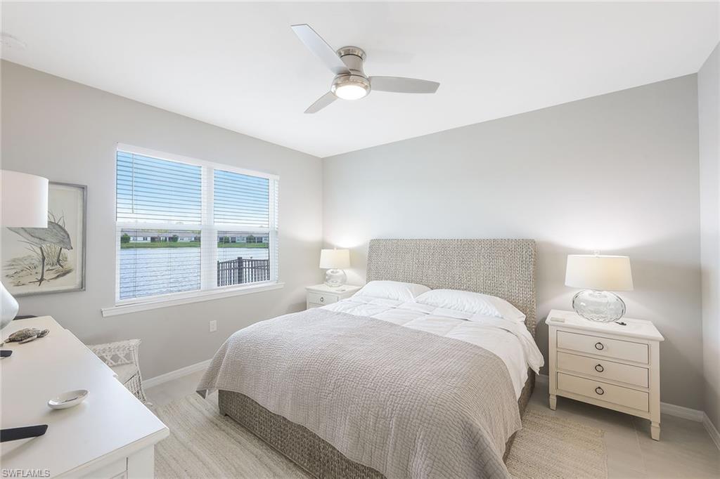 1114 Tranquil Brook Drive Naples, FL 34114 - Photo 14 of 32 a bedroom with a bed and a large window
