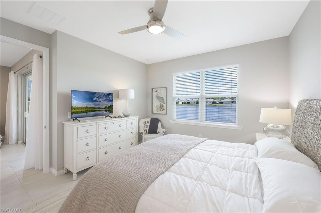 1114 Tranquil Brook Drive Naples, FL 34114 - Photo 15 of 32 a bedroom with a bed and a flat screen tv