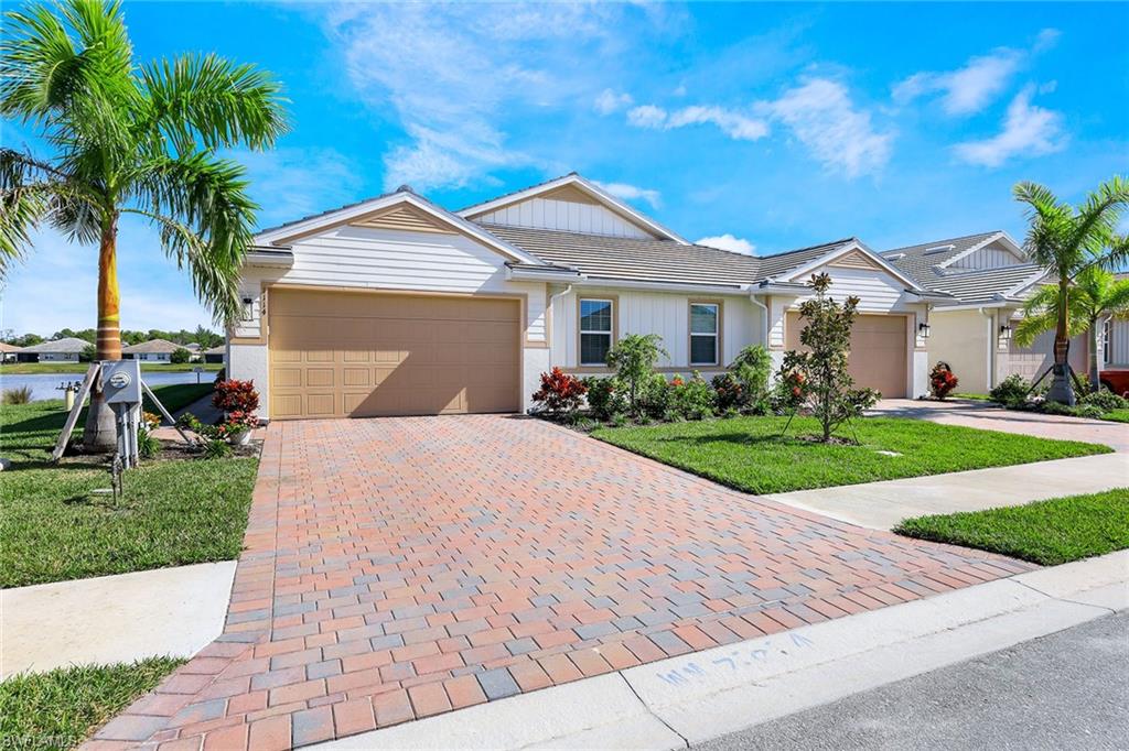 1114 Tranquil Brook Drive Naples, FL 34114 - Photo 2 of 32 a front view of house with yard and green space