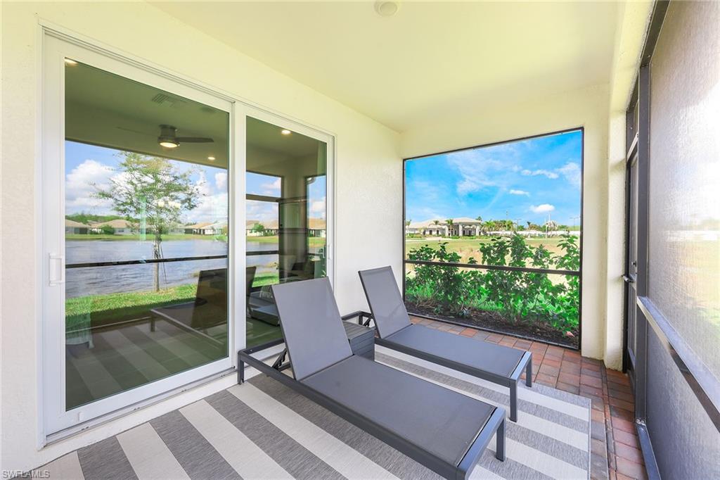 1114 Tranquil Brook Drive Naples, FL 34114 - Photo 23 of 32 a view of two chairs in a room with a window