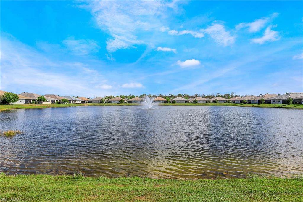 1114 Tranquil Brook Drive Naples, FL 34114 - Photo 24 of 32 a view of a lake with a big yard