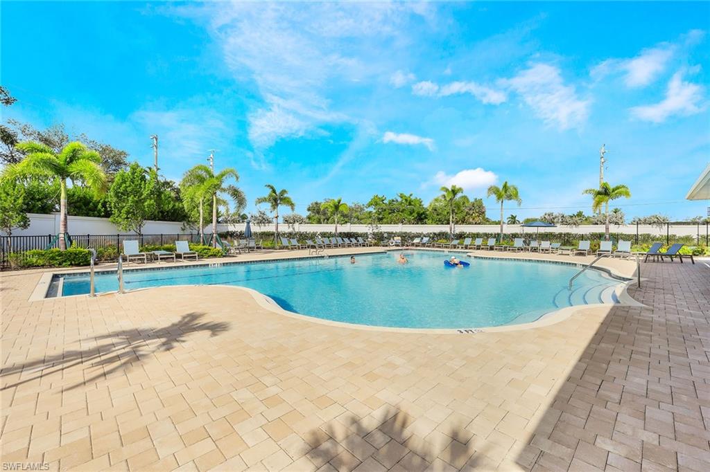 1114 Tranquil Brook Drive Naples, FL 34114 - Photo 28 of 32 a view of a swimming pool and trees in the background