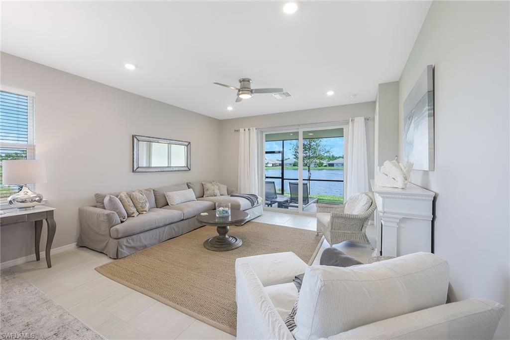 1114 Tranquil Brook Drive Naples, FL 34114 - Photo 5 of 32 a living room with furniture and a large window