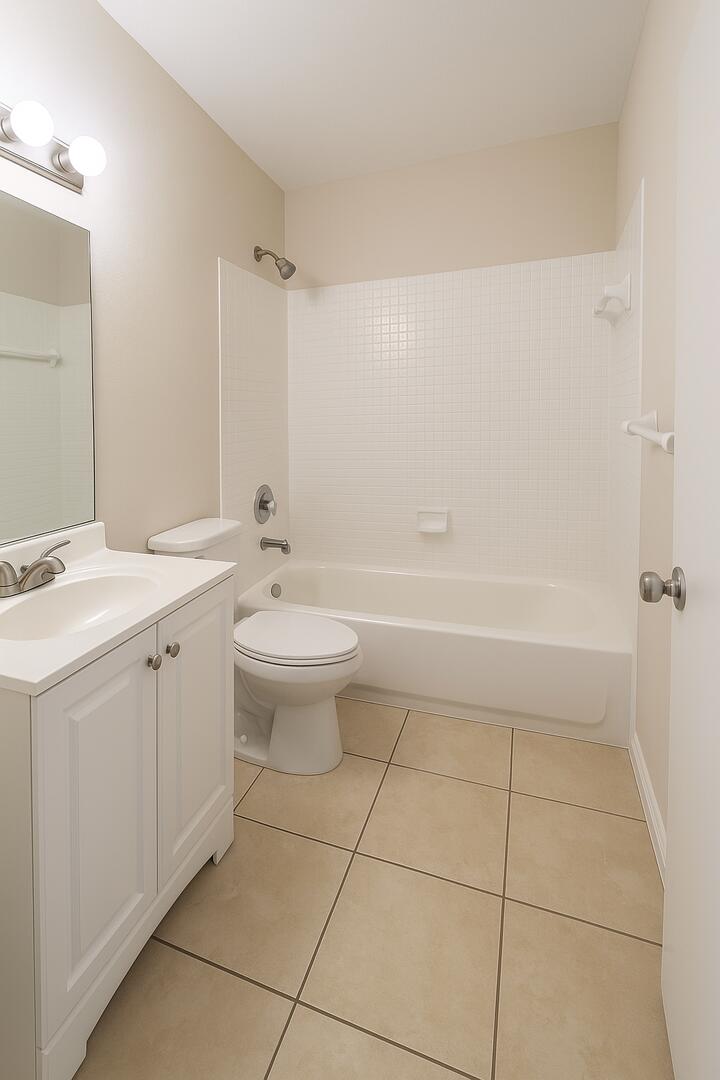 4670 Northeast 5th Avenue, Unit 15 Boca Raton, FL 33431 - Photo 3 of 9 a bathroom with a sink a toilet and shower
