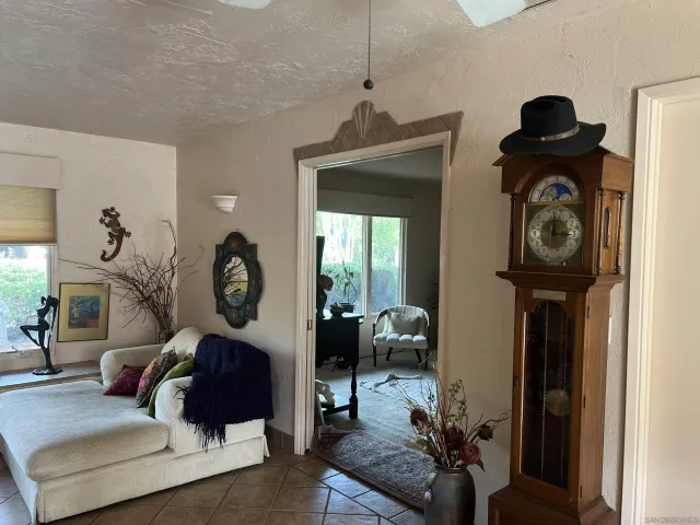 a living room with furniture a mirror and a window