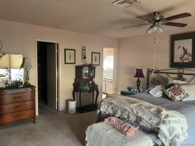 a bedroom with a bed and ceiling fan