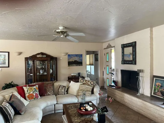 a living room with furniture fireplace and a window