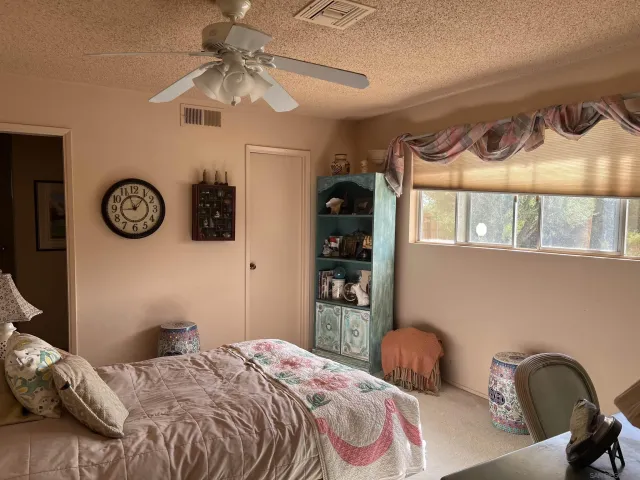 a bedroom with bed and a window