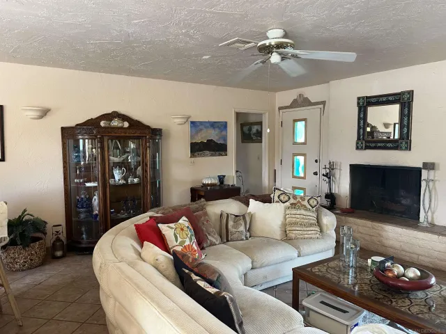 a living room with furniture a fireplace and a chandelier