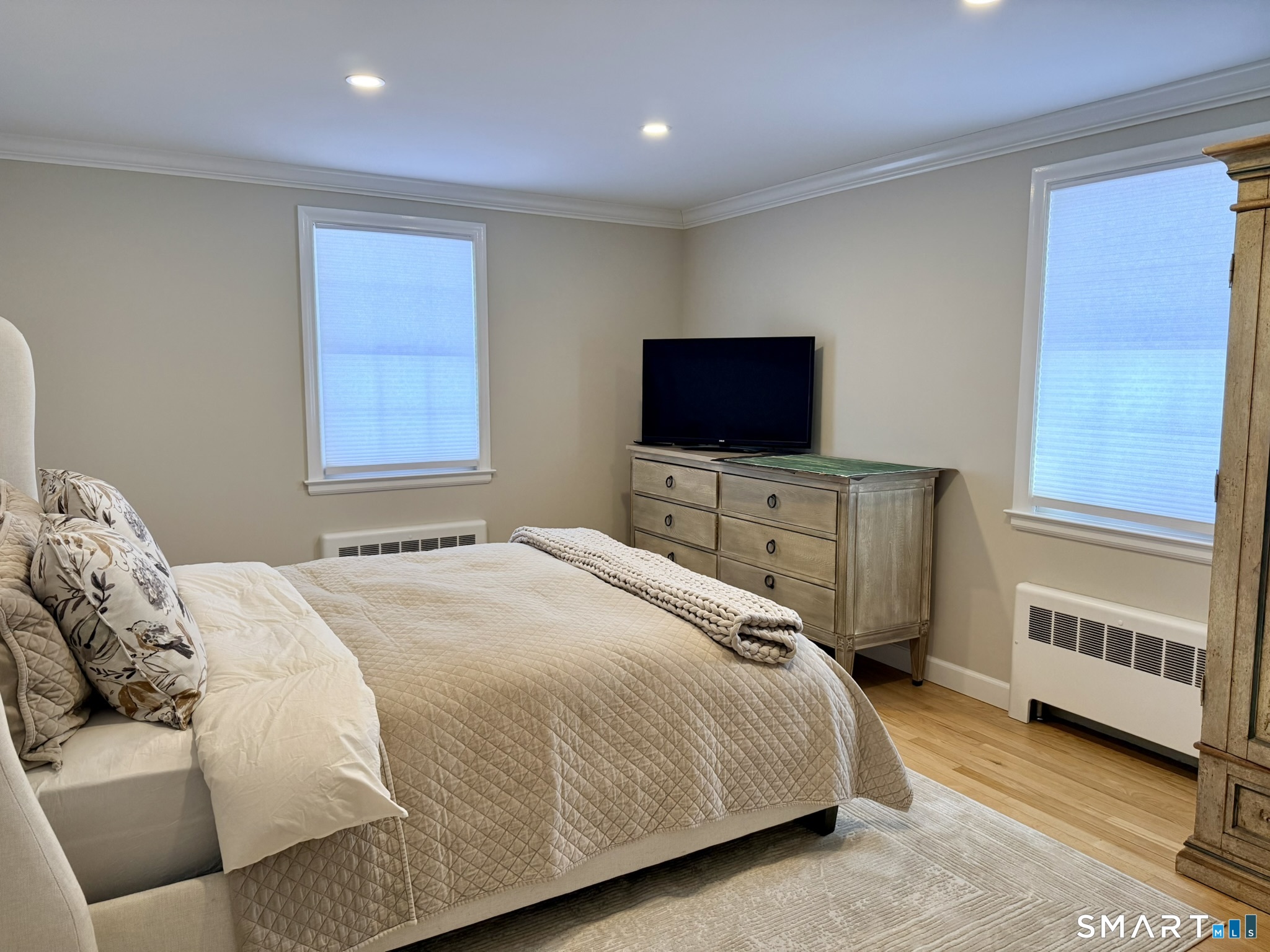 24 Elm Street Wethersfield, CT 06109 - Photo 11 of 24 a bedroom with a bed and a flat screen tv