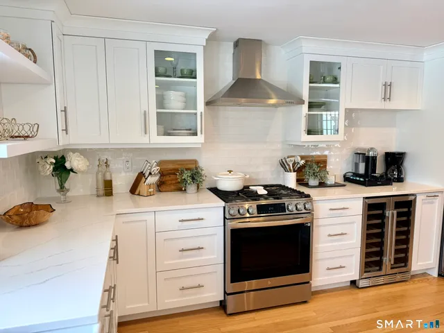 a kitchen with granite countertop a stove and a sink