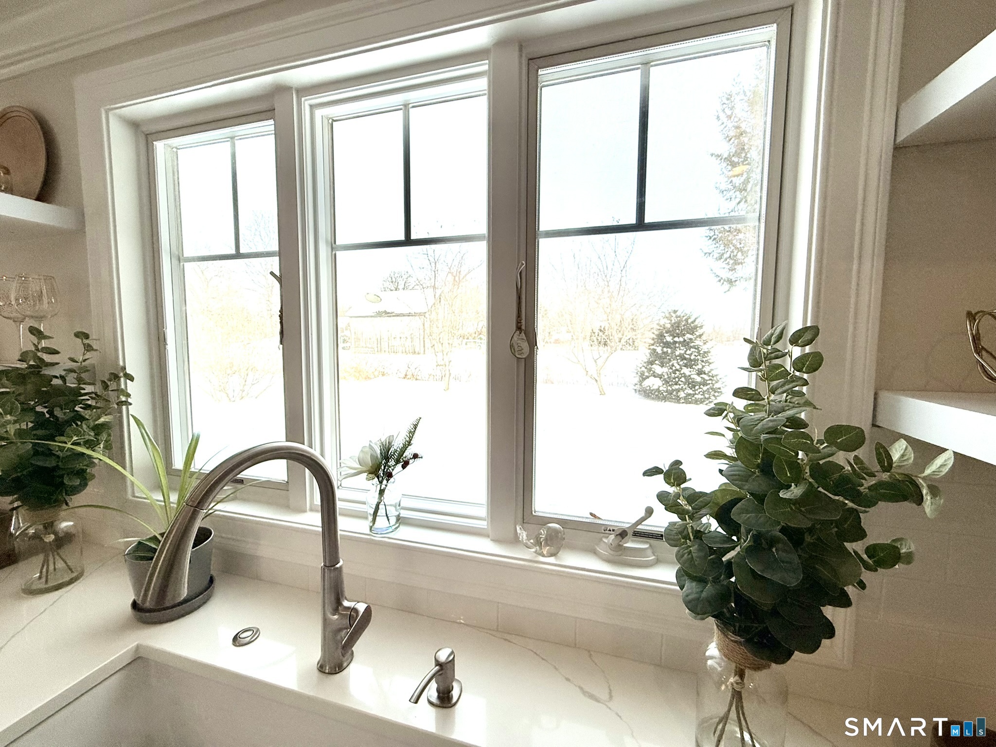 24 Elm Street Wethersfield, CT 06109 - Photo 7 of 24 a close view of a sink a faucet a potted plant and a window