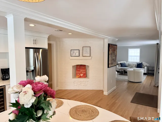 a living room with furniture potted plant and a wooden floor