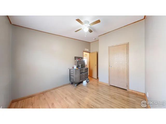 a living room with furniture and a ceiling fan