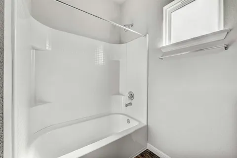 a bathroom with a bathtub and a shower