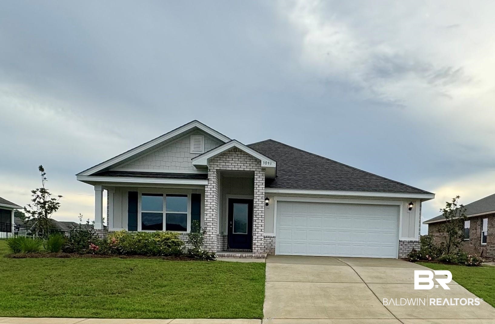 View of front of home featuring a front yard and a garage