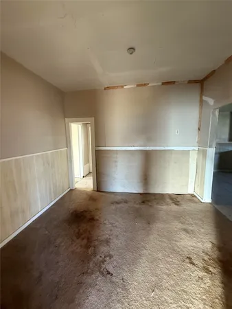 an empty room with a empty space and windows