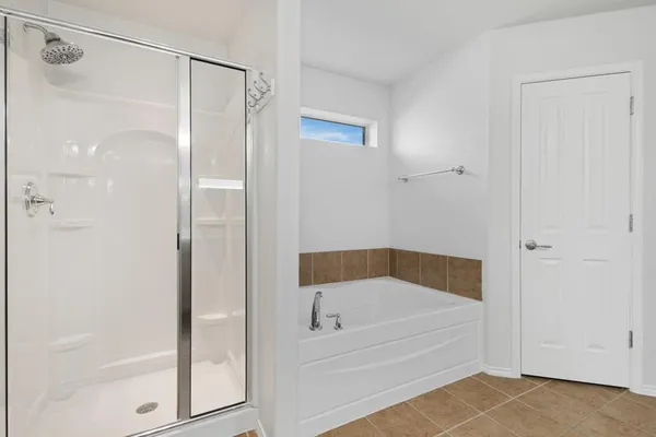 a bathroom with a tub and shower